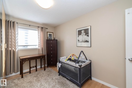 Bedroom featuring light wood finished floors and a textured ceiling - 932 110A Street, Edmonton, AB - Indoor Photo Showing Bedroom