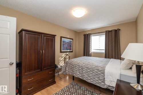 Bedroom featuring light wood-style floors and a textured ceiling - 932 110A Street, Edmonton, AB - Indoor Photo Showing Bedroom