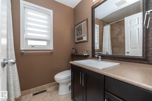 Full bathroom with vanity, a shower with curtain, and light tile patterned floors - 932 110A Street, Edmonton, AB - Indoor Photo Showing Bathroom