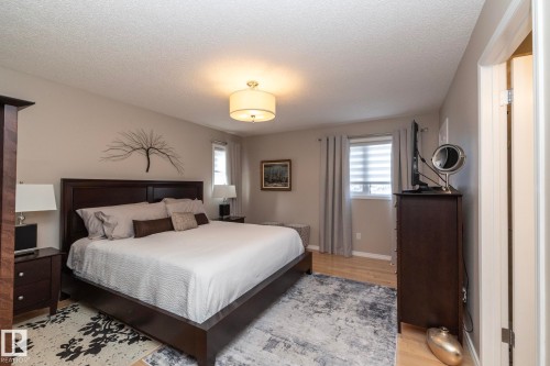 Bedroom with light wood-style flooring and a textured ceiling - 932 110A Street, Edmonton, AB - Indoor Photo Showing Bedroom