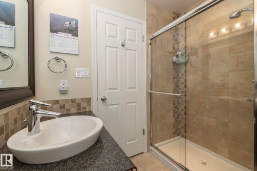 Bathroom featuring a stall shower, vanity, and tile walls - 932 110A Street, Edmonton, AB - Indoor Photo Showing Bathroom