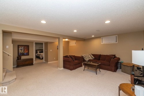 Living area with carpet floors, recessed lighting, and a textured ceiling - 932 110A Street, Edmonton, AB - Indoor Photo Showing Basement