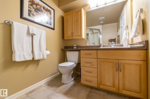 Full bathroom featuring vanity, a stall shower, and light tile patterned floors - 932 110A Street, Edmonton, AB - Indoor Photo Showing Bathroom
