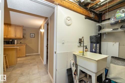 Laundry room with baseboards and a sink - 932 110A Street, Edmonton, AB - Indoor Photo Showing Other Room