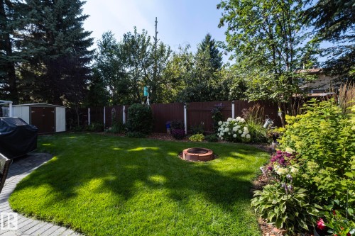 Fenced backyard with a storage shed and an outdoor fire pit - 932 110A Street, Edmonton, AB - Outdoor