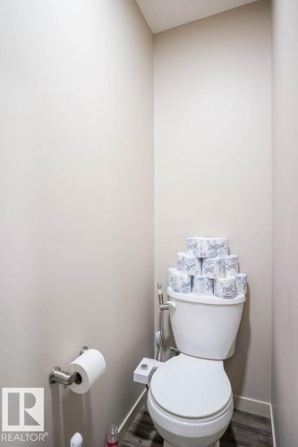 Bathroom featuring toilet and baseboards - 1426 25 Avenue Nw, Edmonton, AB - Indoor Photo Showing Bathroom