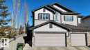 View of front of home with stone siding, driveway, board and batten siding, and a garage - 1426 25 Avenue Nw, Edmonton, AB  - Outdoor 