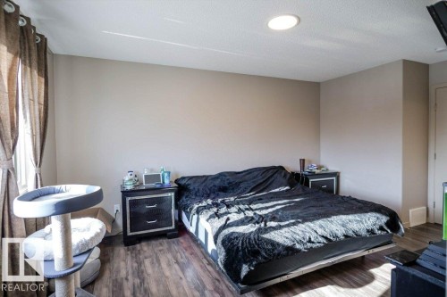 Bedroom featuring dark wood finished floors and baseboards - 1426 25 Avenue Nw, Edmonton, AB - Indoor Photo Showing Bedroom