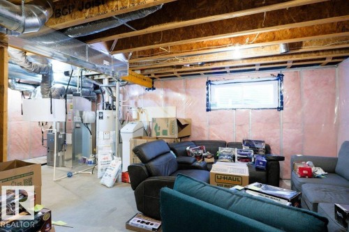 Basement featuring a water softener, water heater, and heating unit - 1426 25 Avenue Nw, Edmonton, AB - Indoor Photo Showing Basement