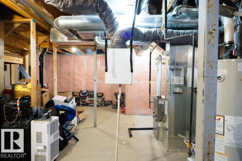 Unfinished below grade area with gas water heater and heating unit - 1426 25 Avenue Nw, Edmonton, AB - Indoor Photo Showing Basement