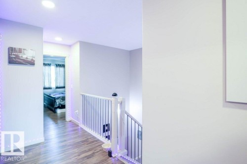 Hall with wood finished floors, recessed lighting, and an upstairs landing - 1426 25 Avenue Nw, Edmonton, AB - Indoor Photo Showing Other Room