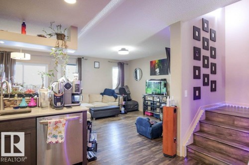 Living room with stairs and dark wood finished floors - 1426 25 Avenue Nw, Edmonton, AB - Indoor Photo Showing Other Room