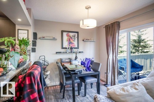 Dining room with wood finished floors and a textured ceiling - 1426 25 Avenue Nw, Edmonton, AB - Indoor