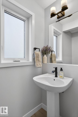 Bathroom featuring baseboards and wood finished floors - 9103 120 Avenue, Edmonton, AB - Indoor Photo Showing Bathroom