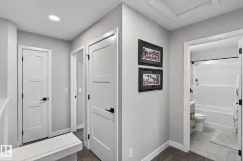 Hallway featuring dark colored carpet and dark tile patterned floors - 9103 120 Avenue, Edmonton, AB - Indoor Photo Showing Other Room