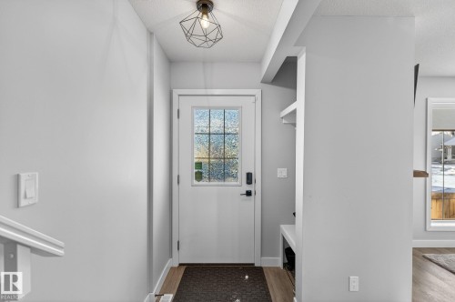 Mudroom featuring light wood-style flooring and a textured ceiling - 9103 120 Avenue, Edmonton, AB - Indoor Photo Showing Other Room