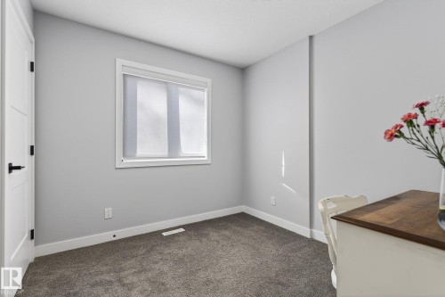 Unfurnished room with dark carpet and baseboards - 9103 120 Avenue, Edmonton, AB - Indoor Photo Showing Other Room