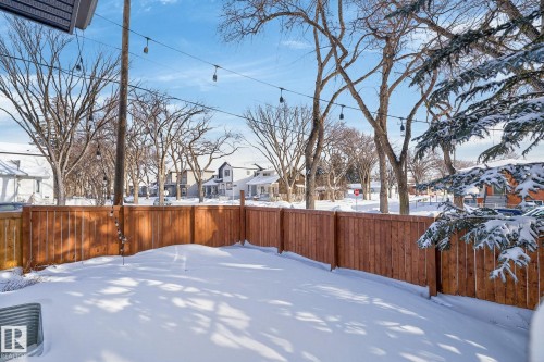 Snowy yard featuring a residential view and a fenced backyard - 9103 120 Avenue, Edmonton, AB - Outdoor