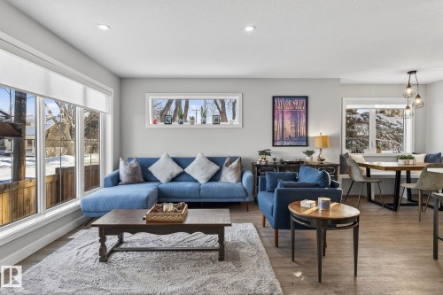 Living area featuring healthy amount of natural light, wood finished floors, and recessed lighting - 9103 120 Avenue, Edmonton, AB - Indoor Photo Showing Living Room