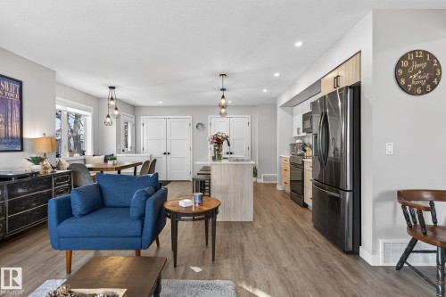 Living room with recessed lighting, light wood-style floors, and a textured ceiling - 9103 120 Avenue, Edmonton, AB - Indoor Photo Showing Living Room