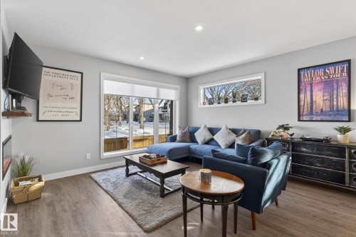 Living room with wood finished floors and recessed lighting - 9103 120 Avenue, Edmonton, AB - Indoor Photo Showing Living Room