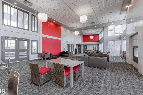 Common area with a high ceiling and recessed lighting - 332 5151 Windermere Boulevard, Edmonton, AB - Indoor With Fireplace