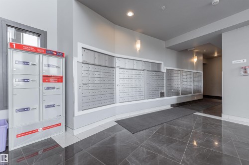 View of community featuring mail area and recessed lighting - 332 5151 Windermere Boulevard, Edmonton, AB - Indoor Photo Showing Other Room