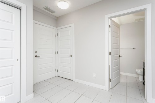 Interior space featuring baseboards and light tile patterned floors - 332 5151 Windermere Boulevard, Edmonton, AB - Indoor