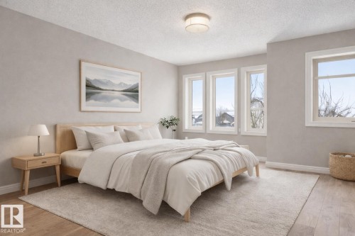 Bedroom featuring light wood-type flooring and a textured ceiling - 2435 Austin Crescent, Edmonton, AB - Indoor Photo Showing Bedroom