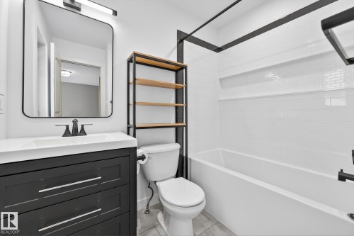 Full bathroom with vanity, tub / shower combination, and light tile patterned flooring - 2435 Austin Crescent, Edmonton, AB - Indoor Photo Showing Bathroom