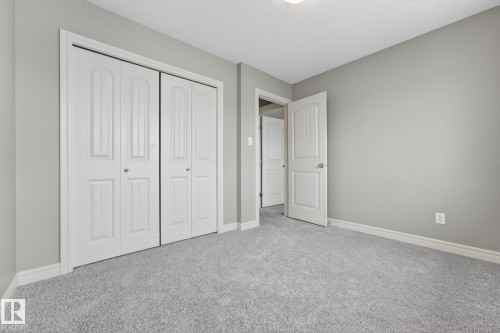 Unfurnished bedroom with carpet, a closet, and a textured ceiling - 2435 Austin Crescent, Edmonton, AB - Indoor