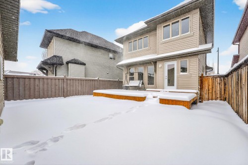 Snow covered house featuring a wooden deck and a fenced backyard - 2435 Austin Crescent, Edmonton, AB - Outdoor