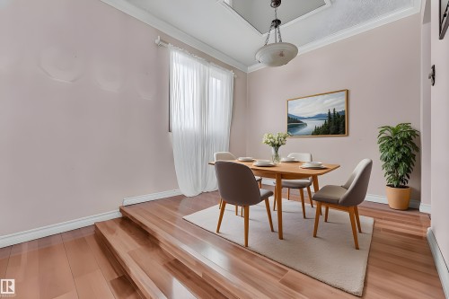 Dining room with light wood finished floors and ornamental molding - 5504 18 Avenue, Edmonton, AB - Indoor Photo Showing Dining Room