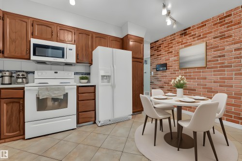 Bedroom with two closets, a textured ceiling, wood finished floors, and ceiling fan - 5504 18 Avenue, Edmonton, AB - Indoor Photo Showing Bedroom