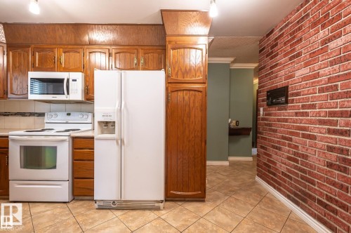 Bathroom featuring vanity and tile walls - 5504 18 Avenue, Edmonton, AB - Indoor Photo Showing Bathroom