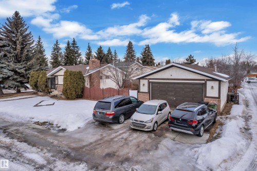 View of front of home with brick siding, a garage, a chimney, and stucco siding - 5504 18 Avenue, Edmonton, AB - Outdoor
