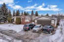 View of front of home with brick siding, a garage, a chimney, and stucco siding - 5504 18 Avenue, Edmonton, AB  - Outdoor 