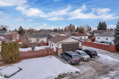View of front of property featuring a residential view, a garage, brick siding, and stucco siding - 5504 18 Avenue, Edmonton, AB - Outdoor