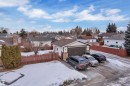View of front of property featuring a residential view, a garage, brick siding, and stucco siding - 5504 18 Avenue, Edmonton, AB  - Outdoor 
