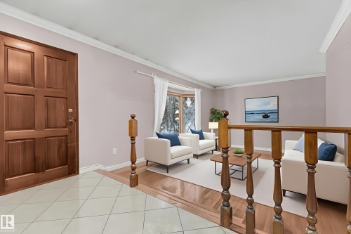 Kitchen featuring brick wall, white appliances, wood finish cabinets, light countertops, and ornamental molding - 5504 18 Avenue, Edmonton, AB - Indoor Photo Showing Kitchen
