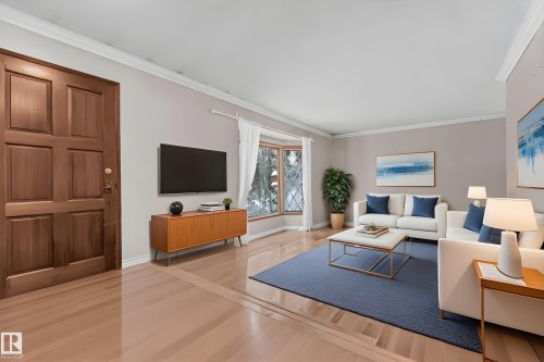 Bedroom with light wood-style floors, ceiling fan, a textured ceiling, and wallpapered walls - 5504 18 Avenue, Edmonton, AB - Indoor Photo Showing Bedroom