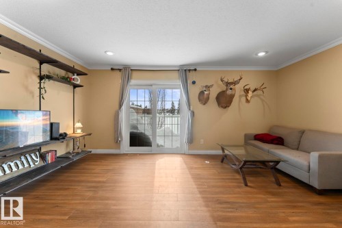 Living room with wood finished floors, crown molding, and recessed lighting - 7 1001 7 Avenue, Cold Lake, AB - Indoor