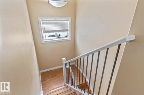 Staircase featuring wood finished floors - 7 1001 7 Avenue, Cold Lake, AB - Indoor Photo Showing Other Room