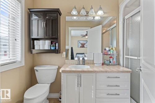 Bathroom featuring vanity and a shower with door - 7 1001 7 Avenue, Cold Lake, AB - Indoor Photo Showing Bathroom