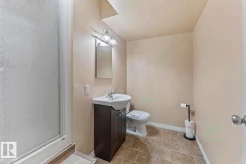 Full bath featuring a shower stall, vanity, and light tile patterned floors - 7 1001 7 Avenue, Cold Lake, AB - Indoor Photo Showing Bathroom