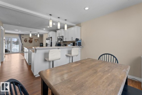 Dining room with dark wood-style floors, beam ceiling, and recessed lighting - 7 1001 7 Avenue, Cold Lake, AB - Indoor