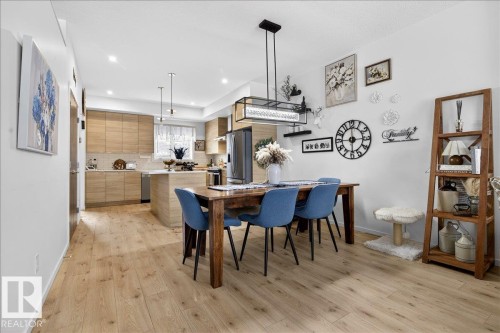 Dining room featuring light wood-type flooring - 6609 47 Avenue, Beaumont, AB - Indoor Photo Showing Dining Room