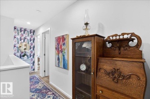 Hallway with baseboards and light colored carpet - 6609 47 Avenue, Beaumont, AB - Indoor Photo Showing Other Room