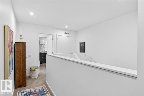Hallway with light carpet, an upstairs landing, and recessed lighting - 6609 47 Avenue, Beaumont, AB - Indoor Photo Showing Other Room