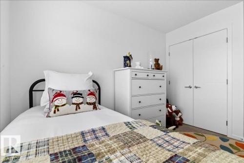 Carpeted bedroom featuring a closet - 6609 47 Avenue, Beaumont, AB - Indoor Photo Showing Bedroom